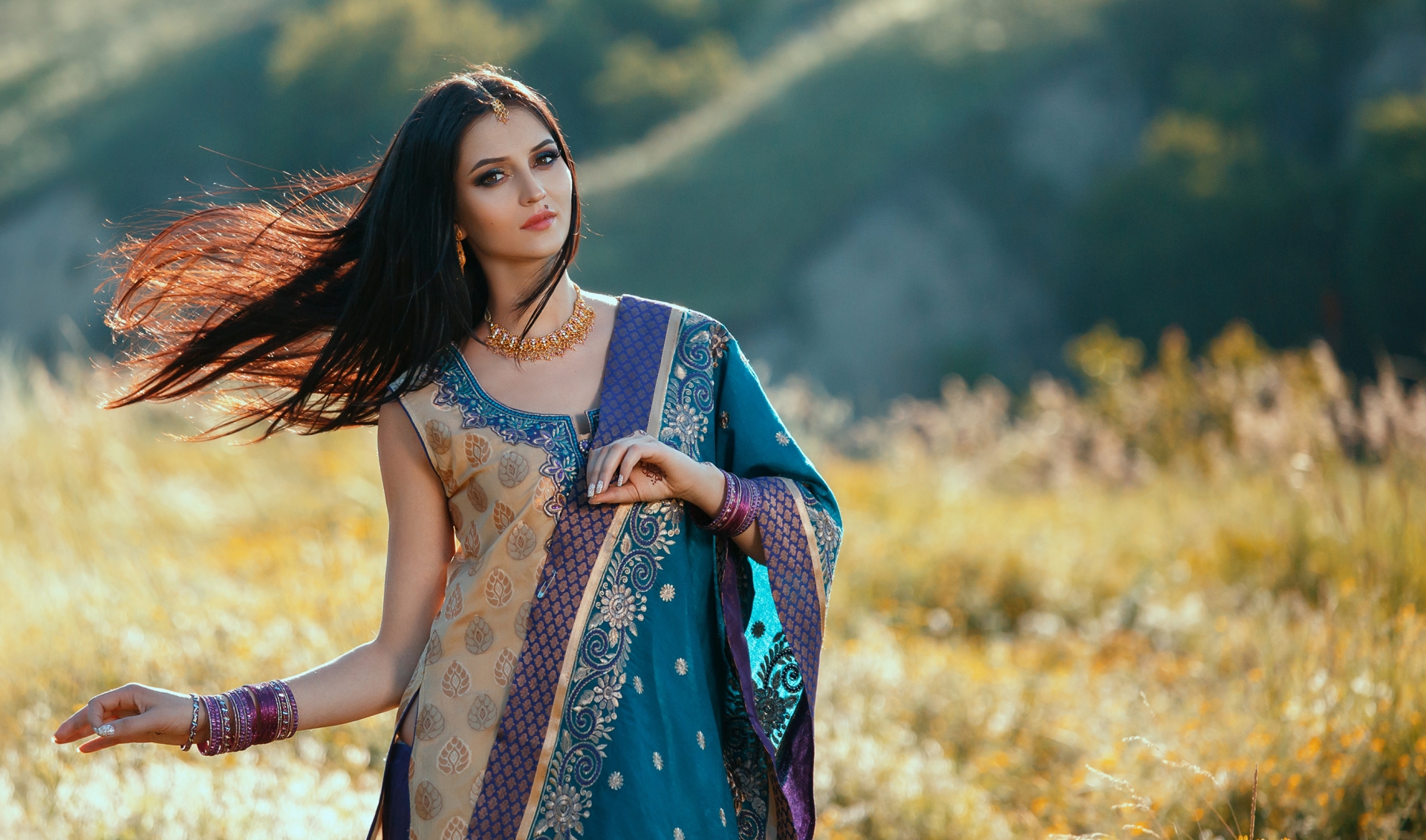 Luxurious Indian woman dancing in traditional natural clothing.